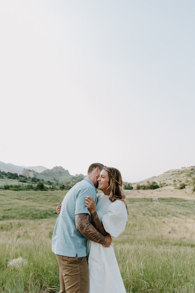 Man hugging his partner and nuzzling into her neck during their Colorado engagement photos
