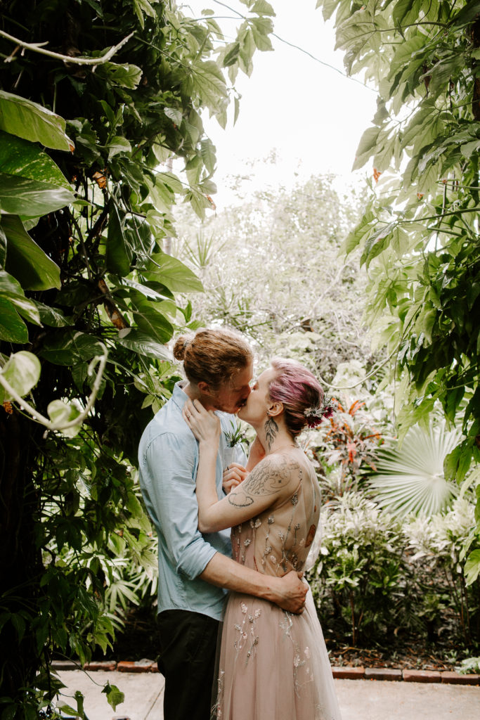 Couple having this first kiss after their hemingway house wedding ceremony