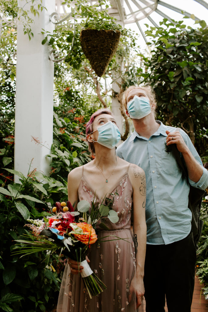 Couple looking up at birds and butterflies during their florida keys elopement