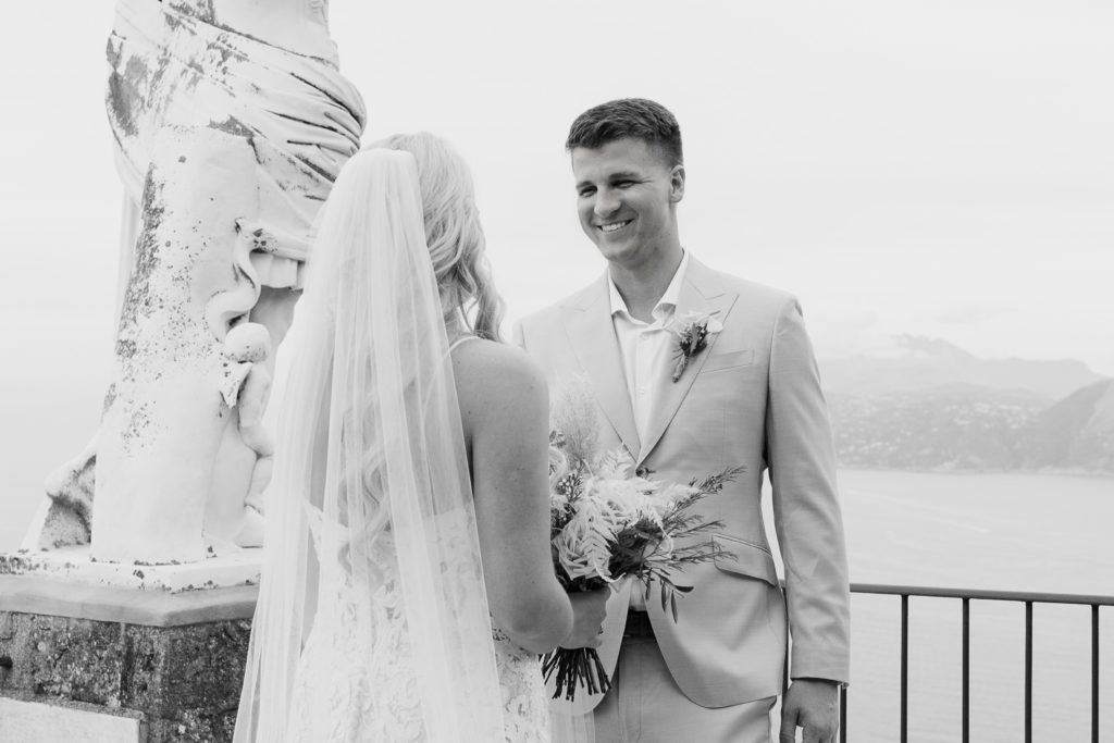 Man smiling after seeing his wife for the first time all dressed up before their Capri elopement