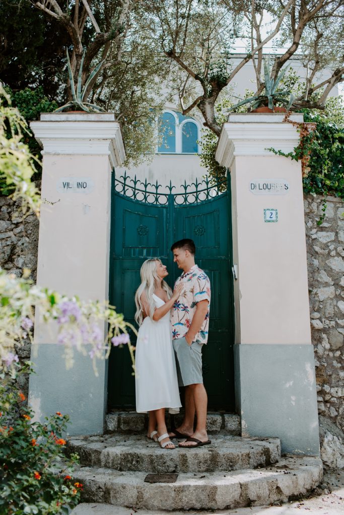 Couple standing in front of a big green door during their Italy elopement