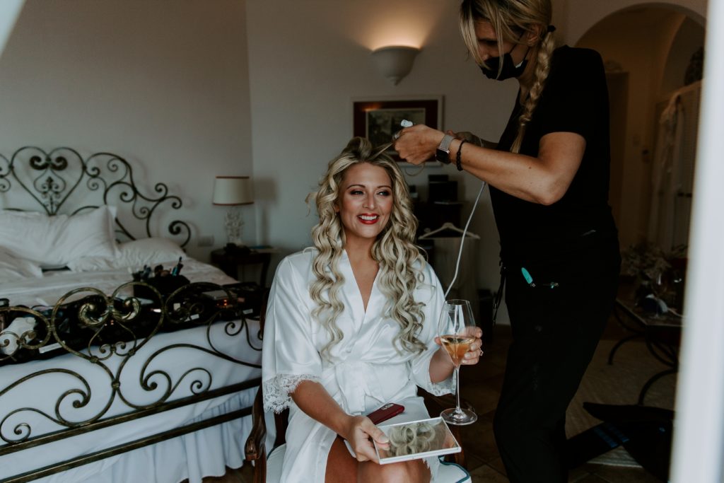 Woman getting her hair and makeup done at the hotel caesar augustus