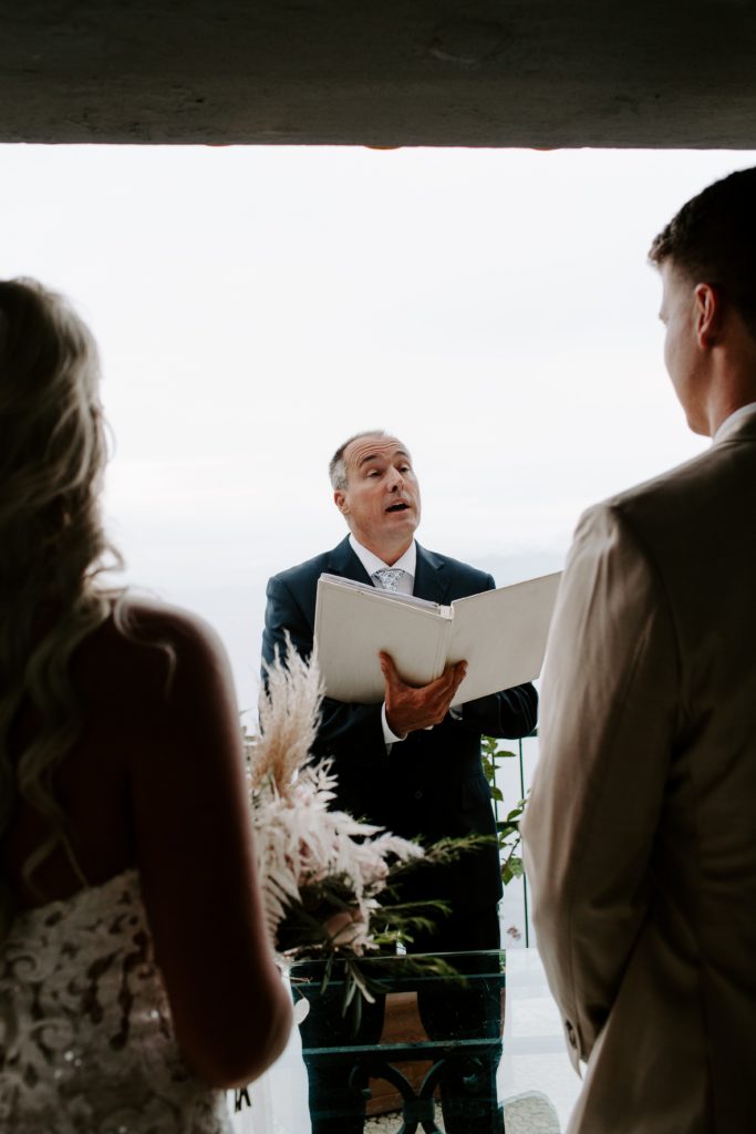 The officiant reading passages to the couple as they are getting married in Italy