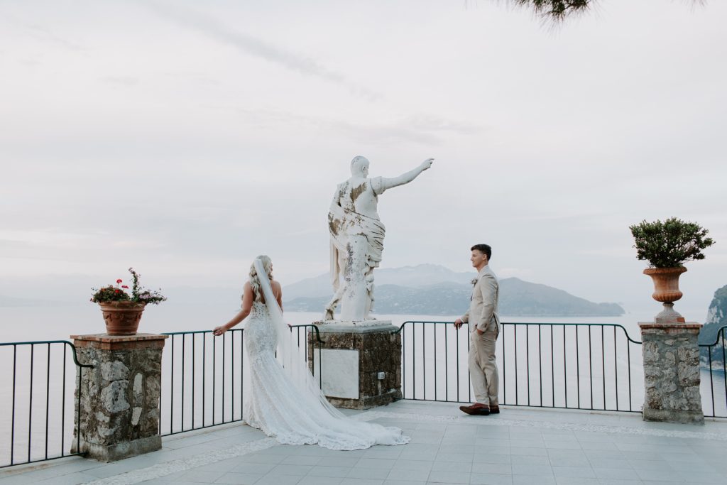 Couple standing on the balcony of their Italian hotel at the end of their elopement day