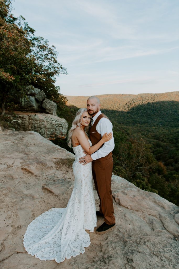 couple standing at an outlook with their arms around each other during their all day Arkansas elopement in the Ozarks