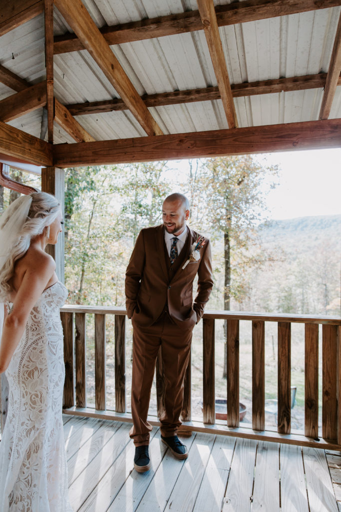 man seeing his bride for the first time in her lace dress during their Arkansas elopement