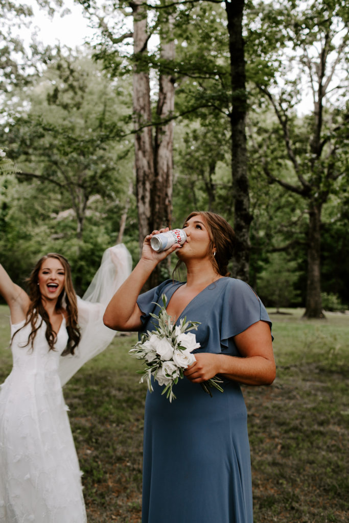 A bride cheering on her bridesmaid as she chugs a beer during their Knoxville wedding