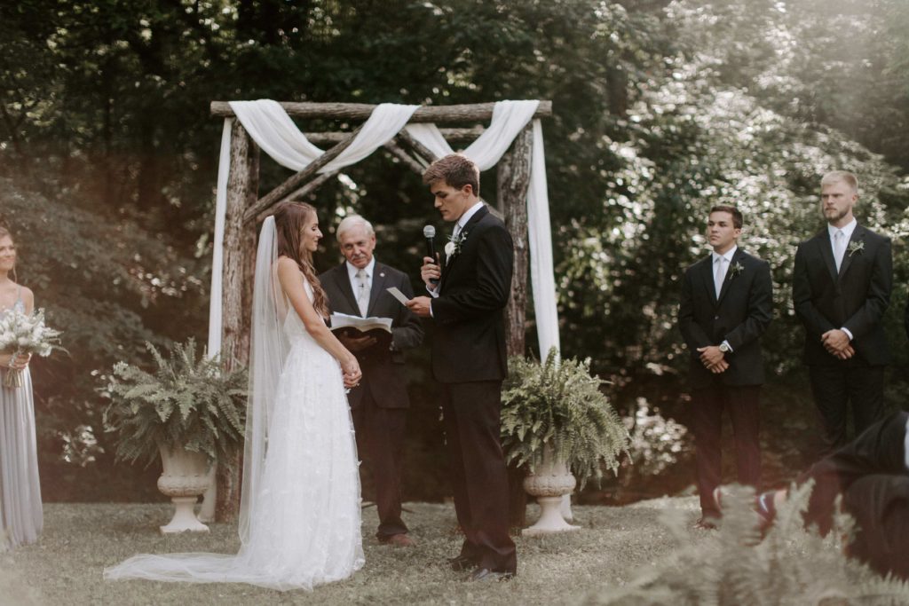 A couple saying their vows to each other in their outdoor east Tennessee wedding in Knoxville