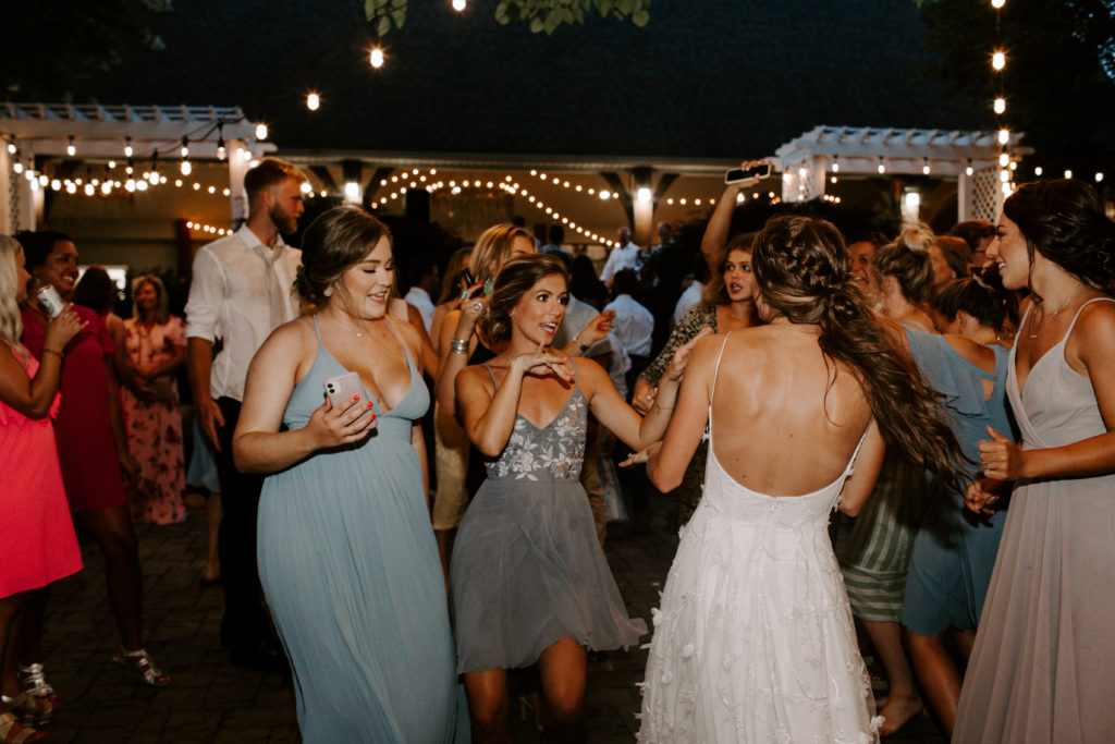 Wedding guests and wedding party dancing the night away in the outdoor pavilion