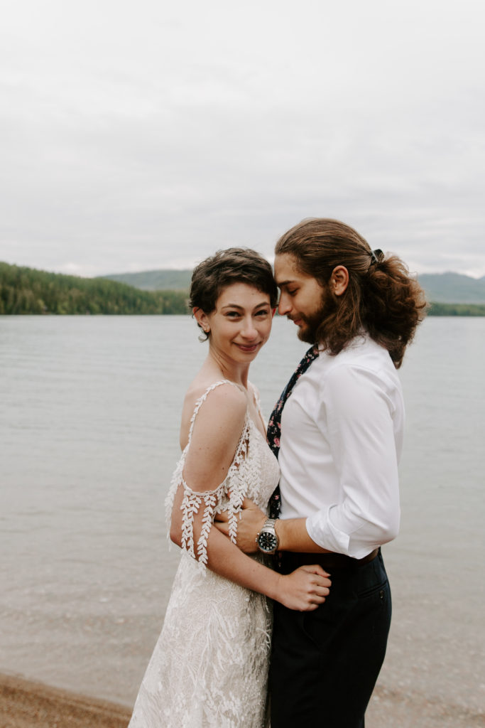 Woman soft smiling as her partner leans into her during their montana elopement