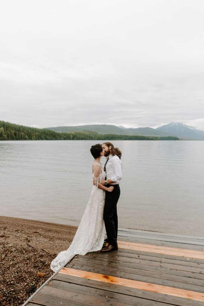 Couple sharing a kiss with the mountains in the background during their montana elopement