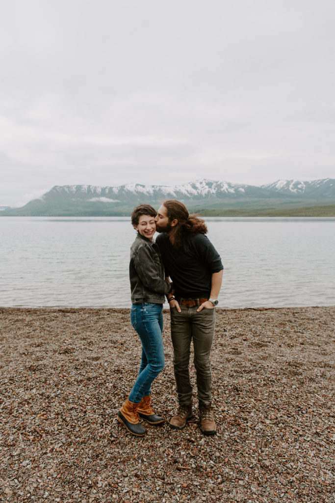 Man giving his partner a kiss on the cheek during their national park elopement