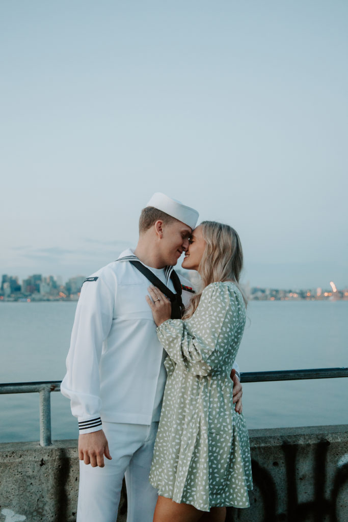 A couple standing face to face leaning their foreheads together as they are looking at each other during their Washington engagement photos in Seattle