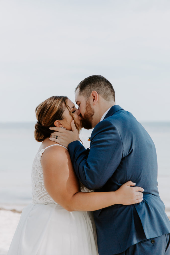 A man giving his partner a big kiss during their Key west elopement at smathers beach