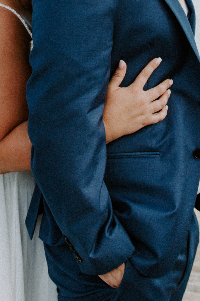 a hands of a woman hugging her partner during their florida keys elopement