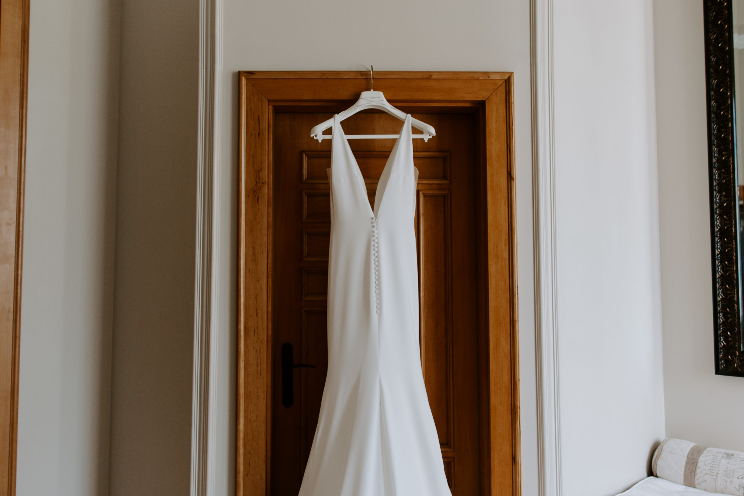 Wedding dress hanging on a door during a Florida wedding
