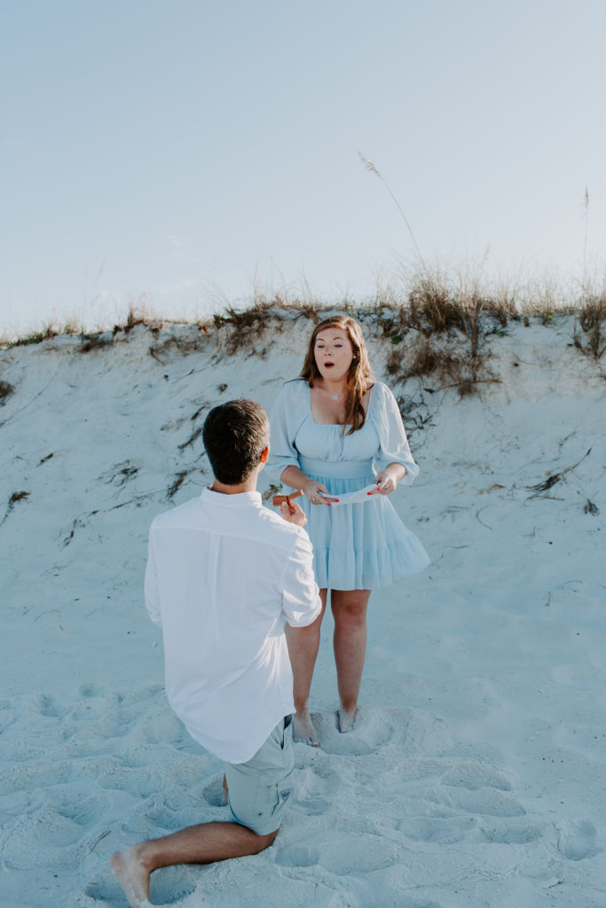 Woman shocked as her partner is down on one knee asking her to marry him during their morning photoshoot