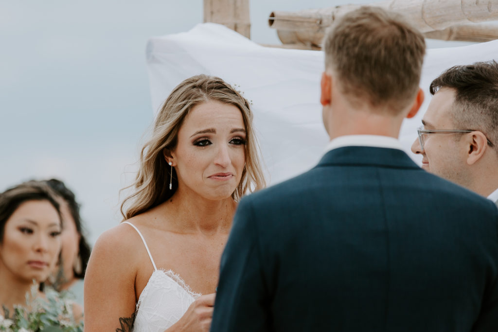 Woman crying as she is saying her vows to her partner during their vow renewal in Florida
