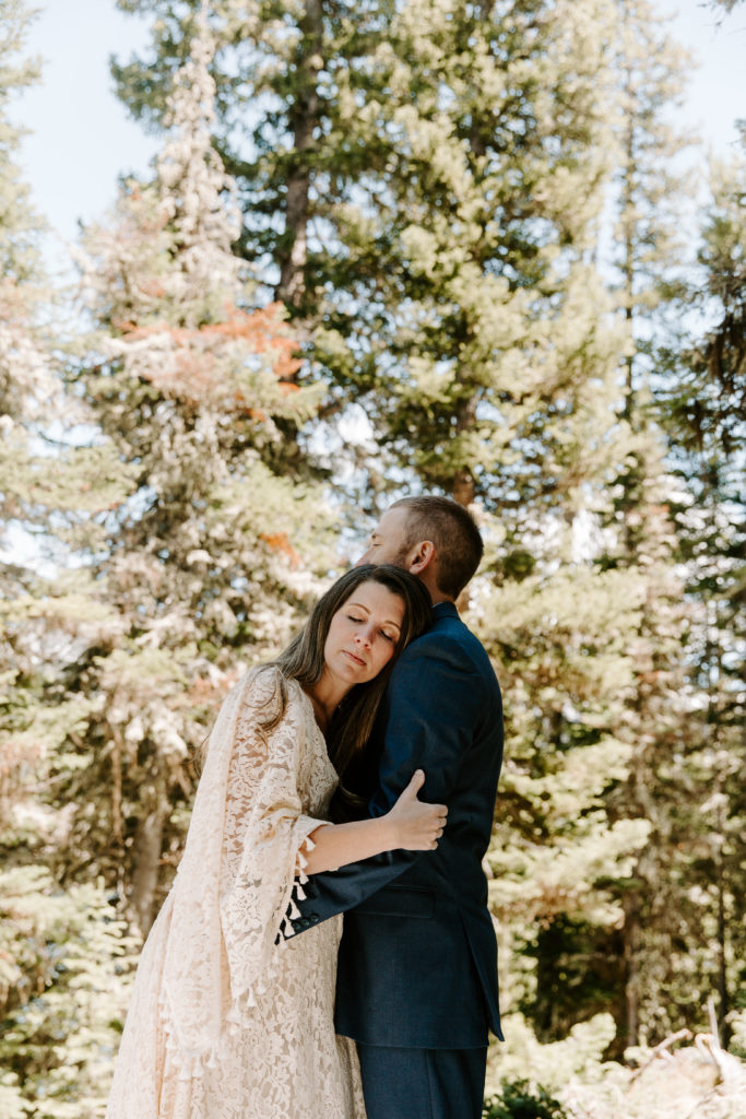 Newly wed couple holding on to each other with their eyes closed during their Montana wedding