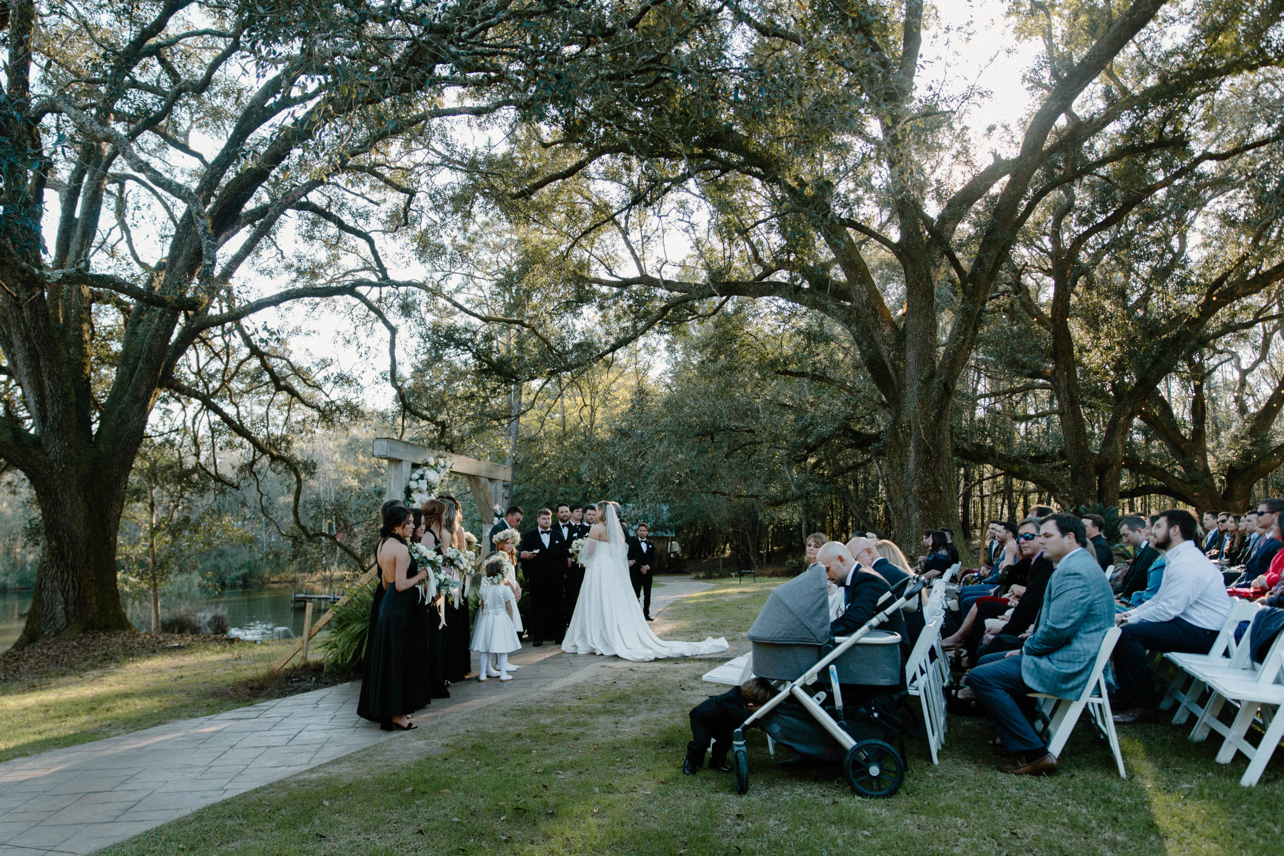 A couple standing at the front of the aisle during their outdoor Pensacola wedding ceremony