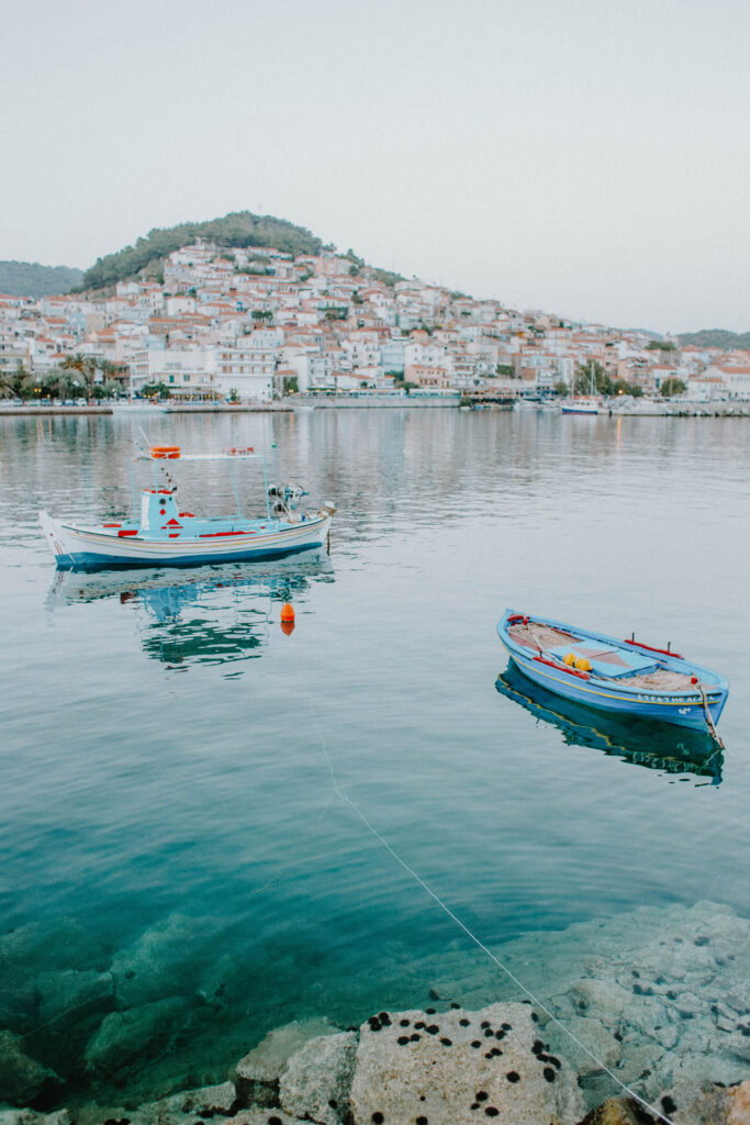 Boats sitting in the water as the sun is setting during an elopement in Greece