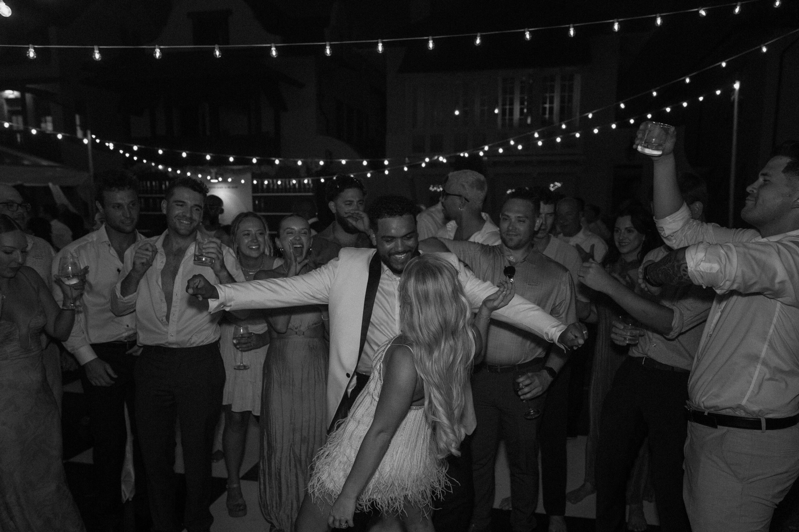 The bride and the groom dancing together as they are surrounded by their family and friends during their outdoor wedding reception in Florida