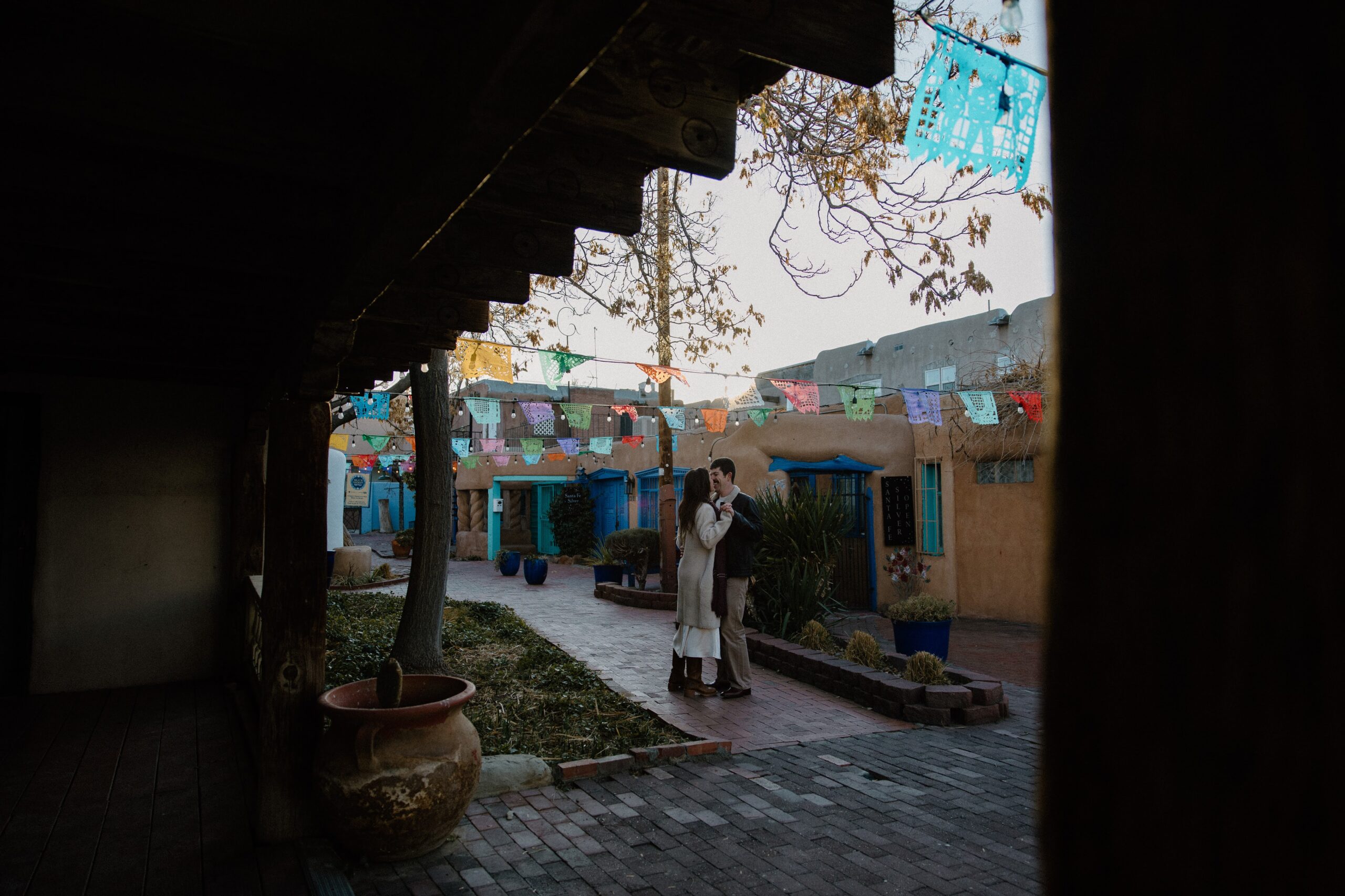 A couple sharing a slow dance as the sun rises in Old Town Albuquerque during their couple photo shoot