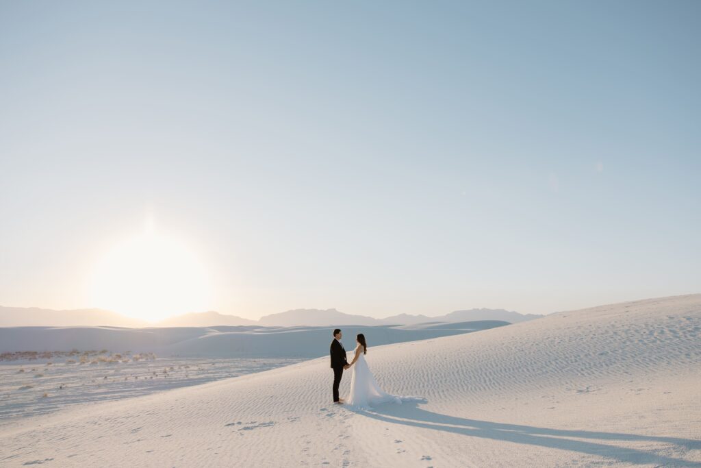 Couple saying their vows at sunset in White Sands National Park during their elopement in New Mexico