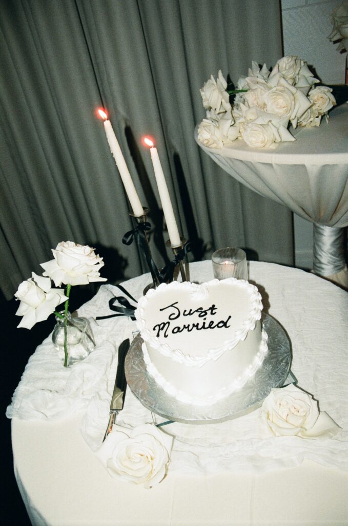 "Just married cake" surrounded by candles and flowers during a Florida elopement