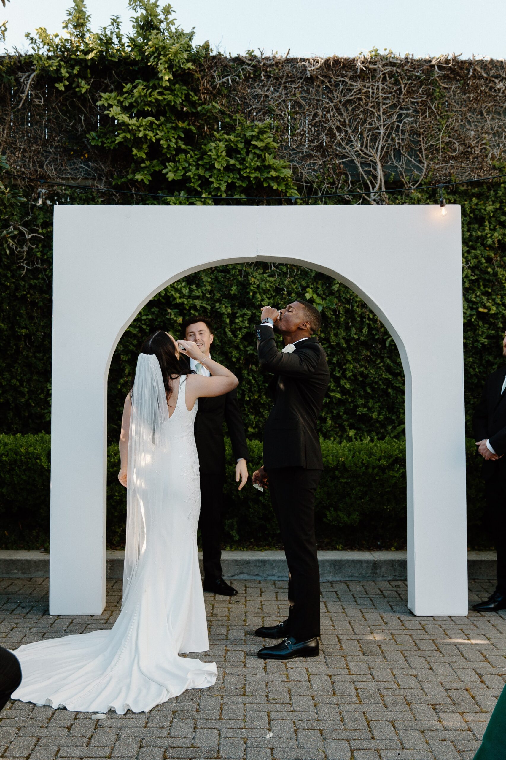 A couple sharing a shot during their wedding ceremony at 5eleven Palafox in downtown Pensacola Tips for Planning a Big Wedding That Feels Personal