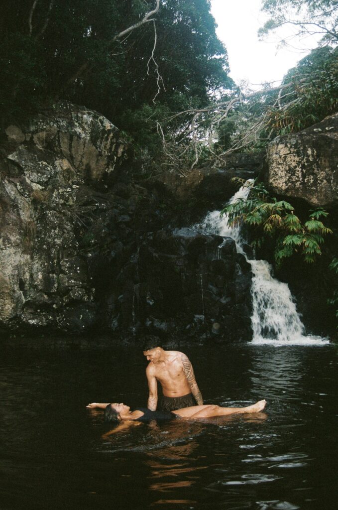 A couple swimming after hiking to their elopement ceremony location in Hawaii adventure elopement ideas