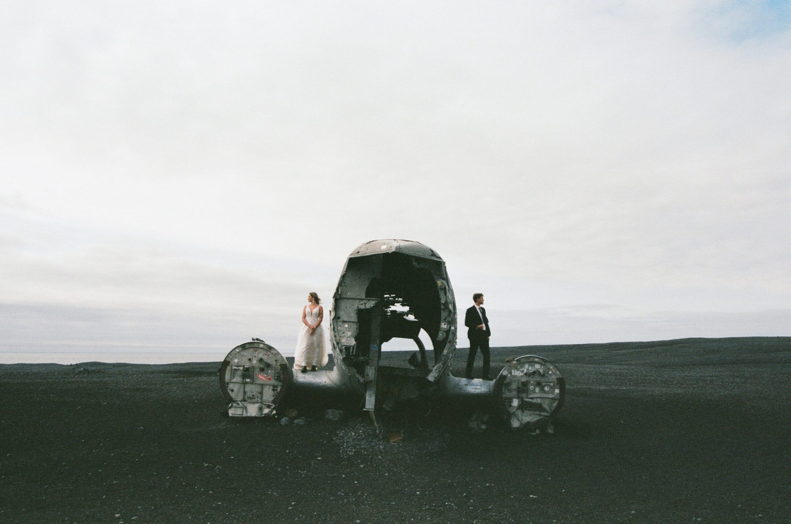 Intimate couple portraits of Josie and Ian by the wrecked plane in Iceland