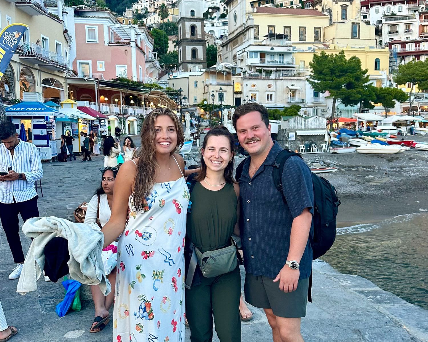 An adventure wedding photographer smiling with her couple at the end of their all day elopement on the coast of italy