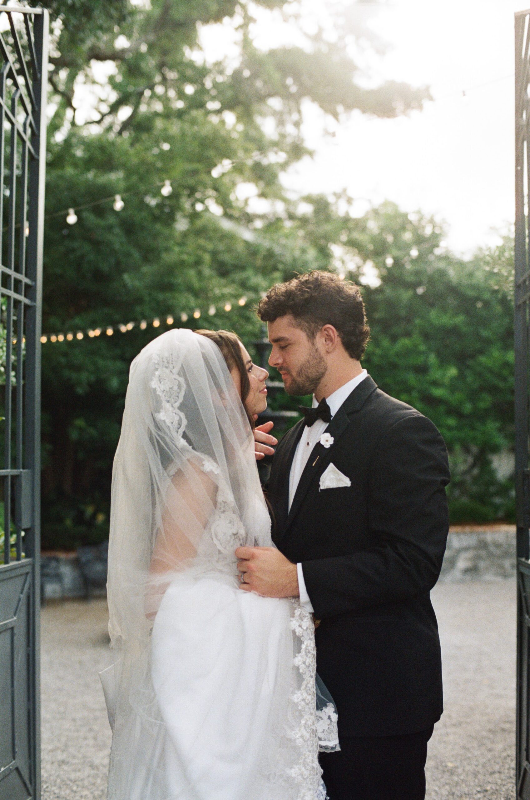 A man bringing his partner in close for a kiss during their summer wedding at Supposey Wedding Venue in Florida
