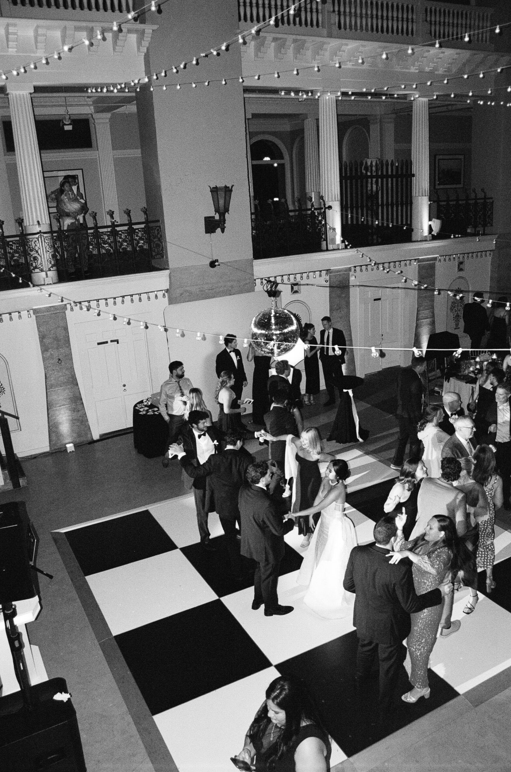 Wedding Guest dancing on a black and white checkered dance floor during a spring wedding in Saint Augustine Florida