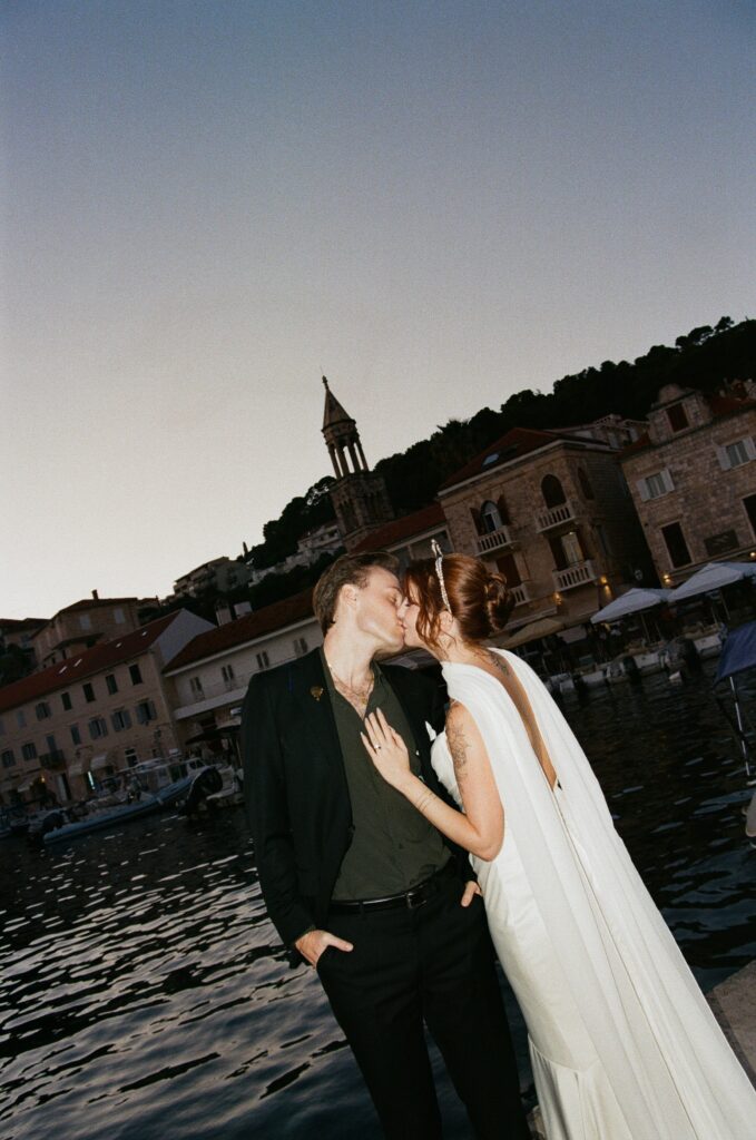 Romantic evening portrait of Matt and Elle with Hvar town skyline at dusk.