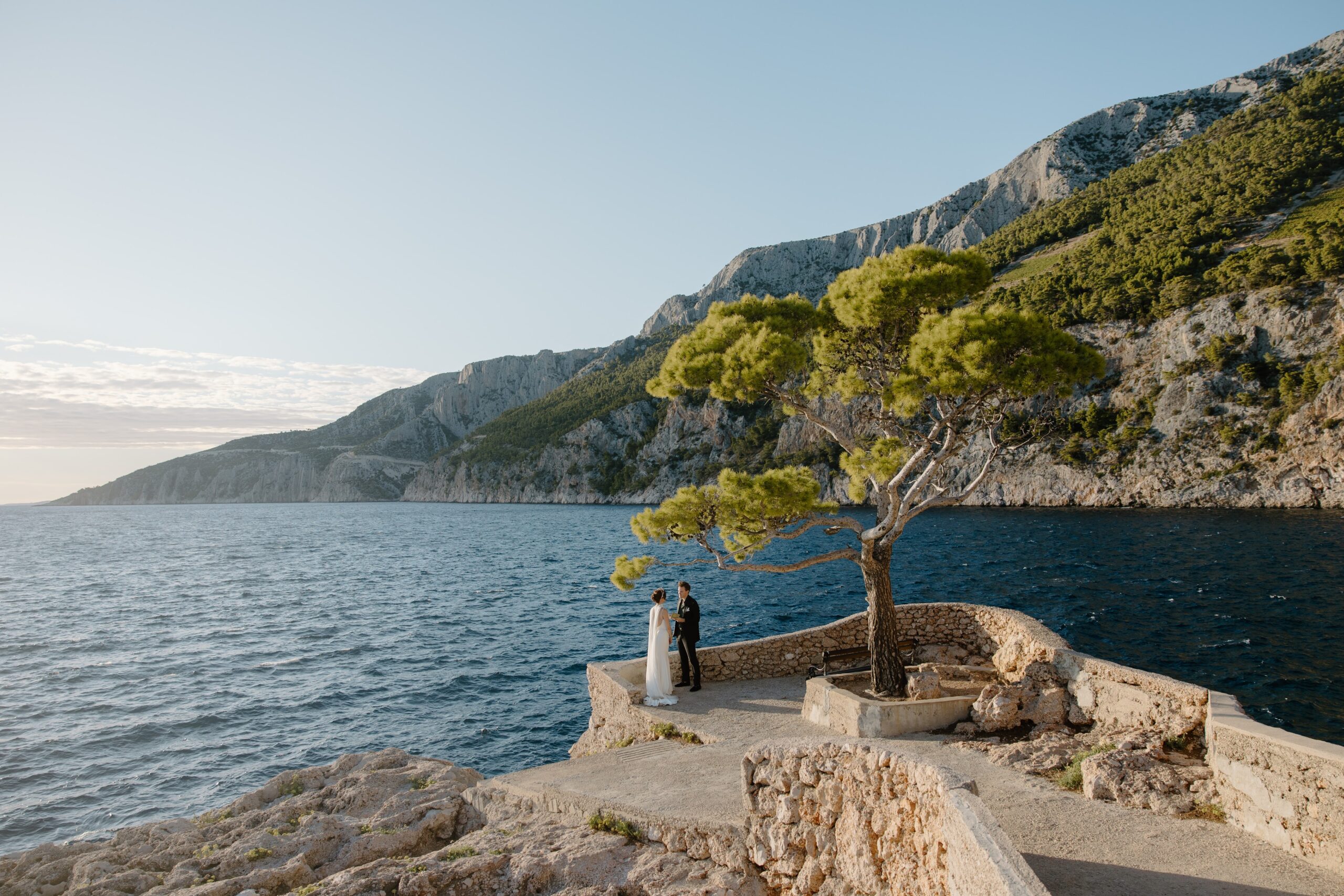 Romantic Adriatic coastline view with Matt and Elle on a cliff saying their vows during their elopement.