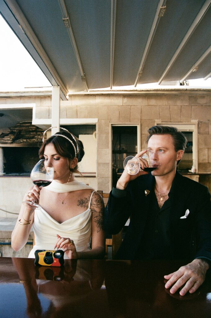 Bride and groom enjoying a celebratory drink together during Hvar wedding adventure.