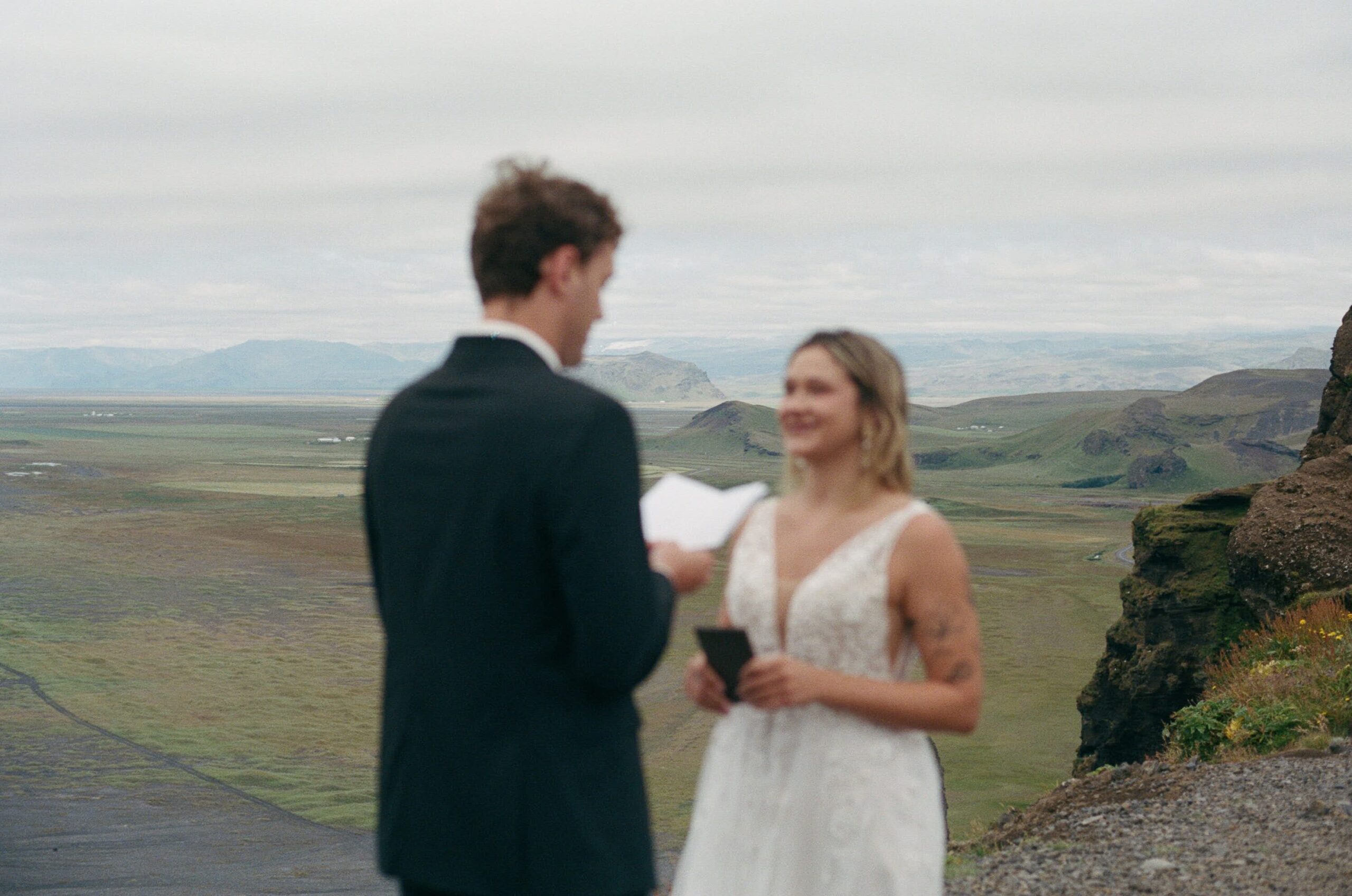 A couple sing their vows on an Iceland Cliffside during their summer, a little man