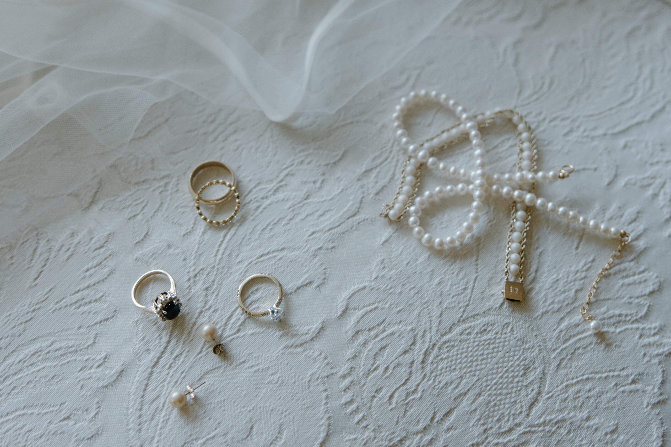 Wedding day jewelry sitting on an chair during a fall Boston wedding