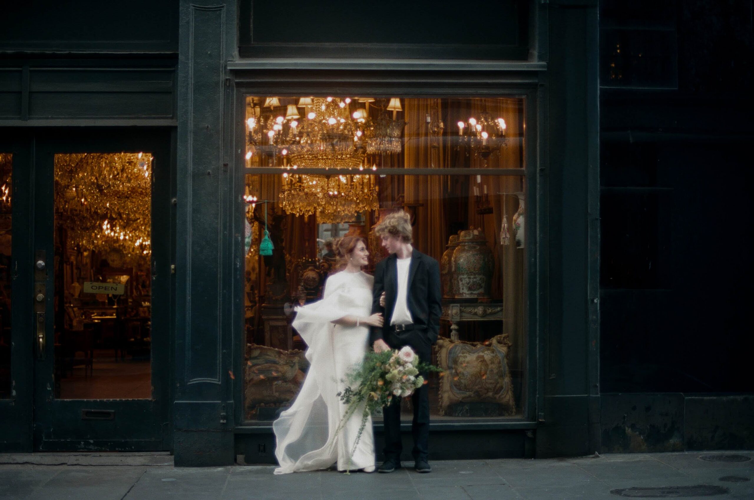Couple exiting historic green storefront in the French Quarter after ceremony on film