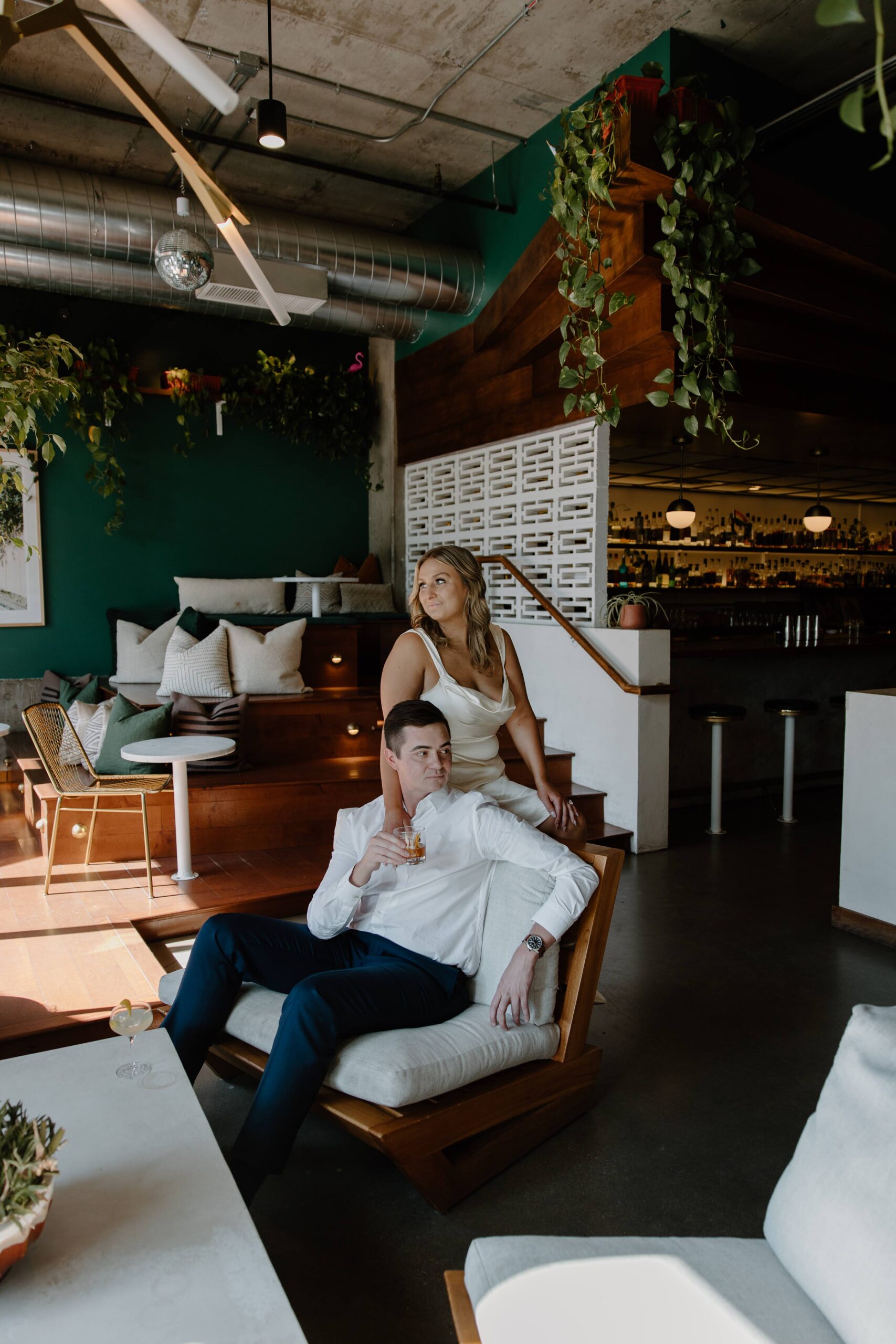 Couple relaxing together in cozy green interior at Lady Jane Bar Denver